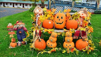 A Halloween display with pumpkins and scarecrows.