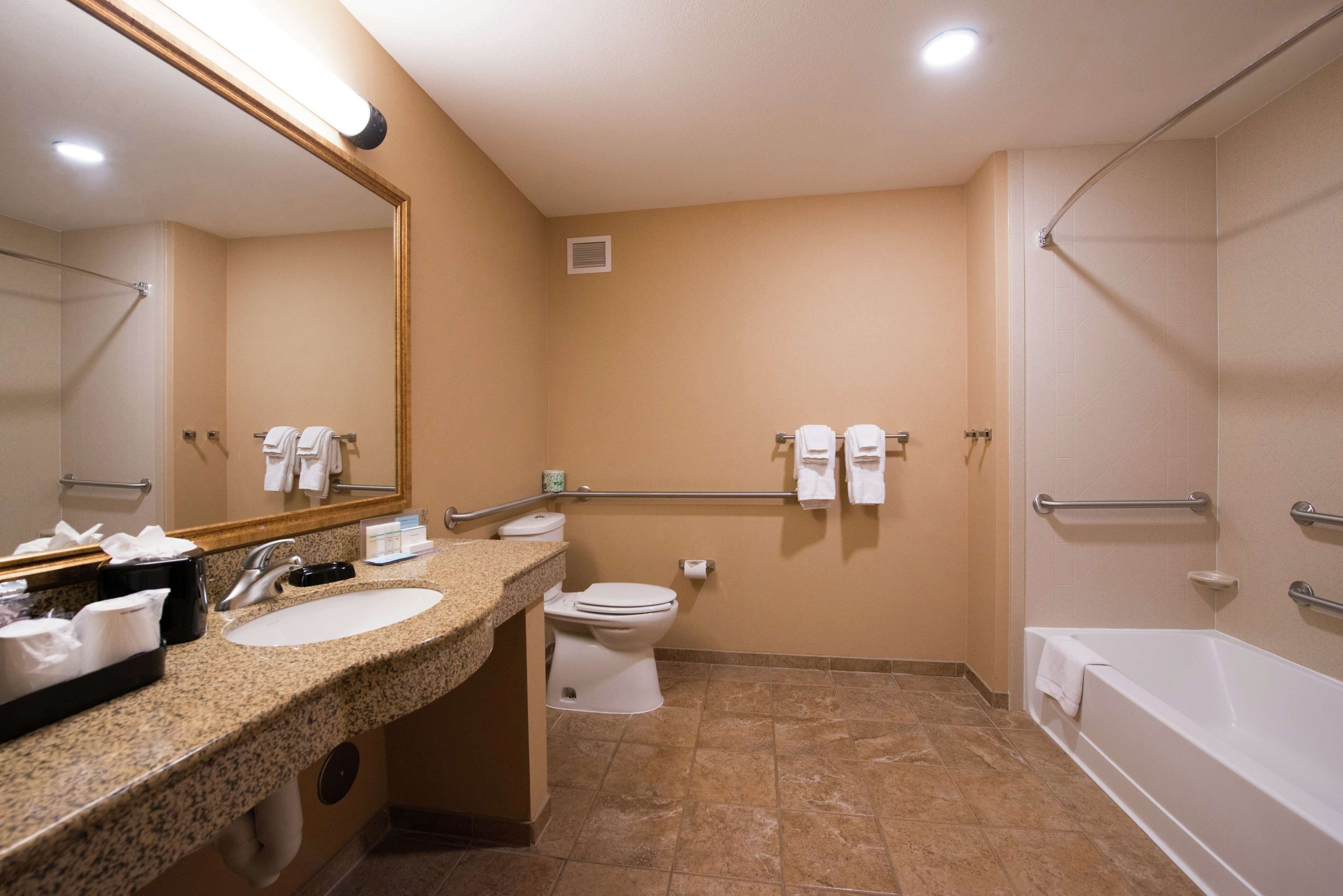 A bathroom with a sink, toilet, and bathtub.