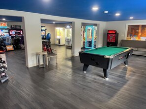 A pool table in a room with arcade games and a 'Prize Cube' machine. - Woodwards White Mountain Resort, BW Signature Collection (Lincoln)