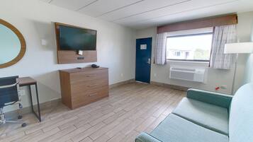Deluxe suite, meerdere bedden, niet-roken, uitzicht op zwembad | Woonruimte | Een 45-inch lcd-televisie met kabelzenders