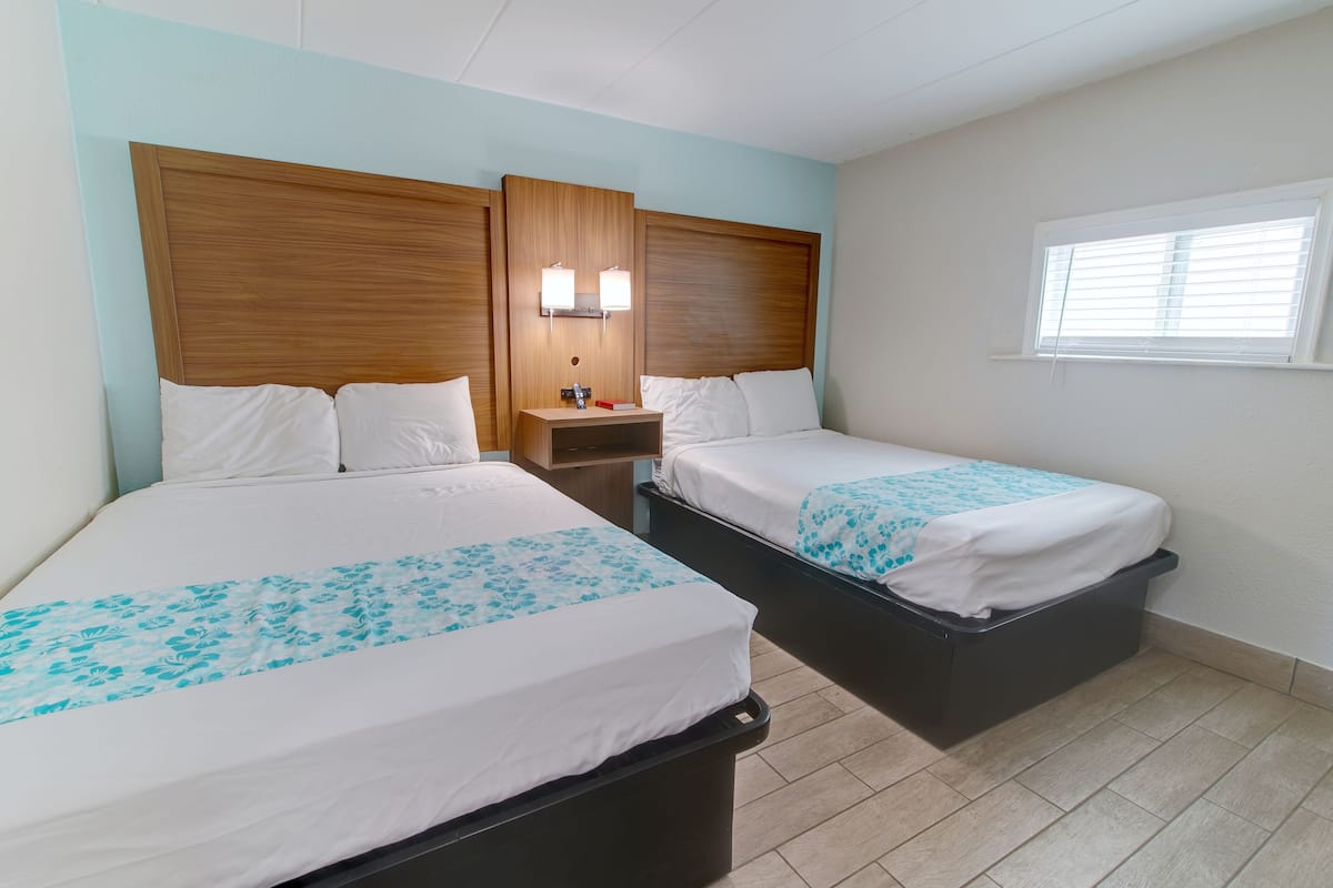 Deluxe Suite, Multiple Beds, Non Smoking, Pool View | Laptop workspace, iron/ironing board, free WiFi, bed sheets