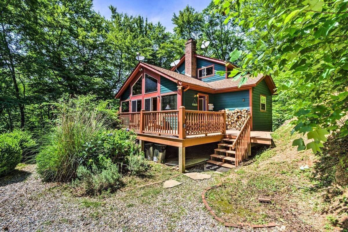 A cabin with a wooden deck, a chimney, and a small porch.