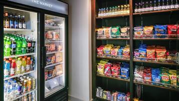 A refrigerated display case stocked with various beverages and snacks.