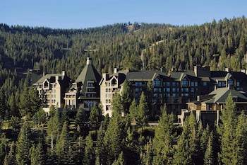 A long dining table set for a meal with a view of the sea. at The Ritz-Carlton, Lake Tahoe