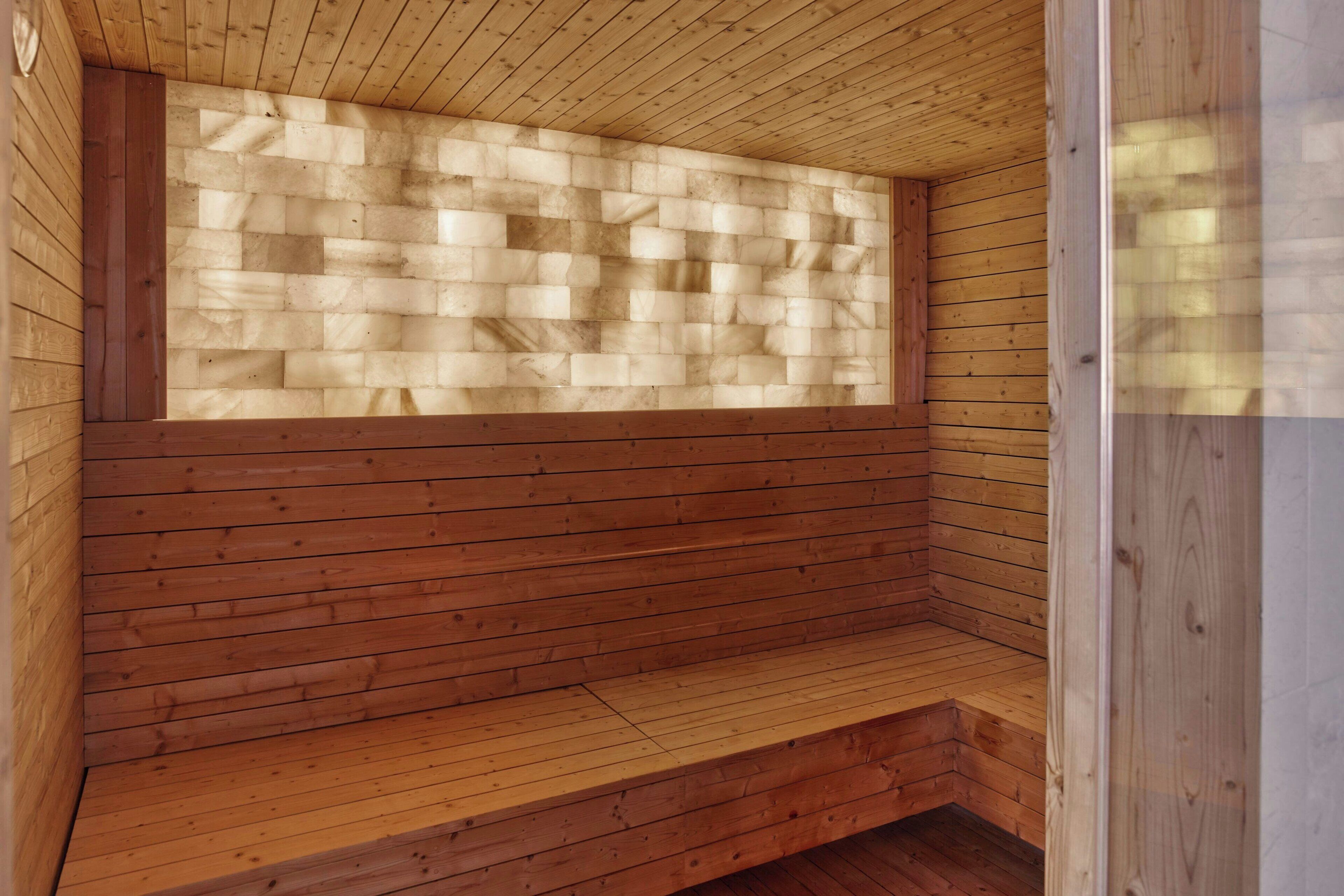 A sauna with wooden benches and a sloped ceiling.