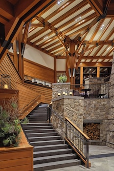 A spacious lobby with a stone fireplace, wooden beams, and comfortable seating areas. at The Ritz-Carlton, Lake Tahoe