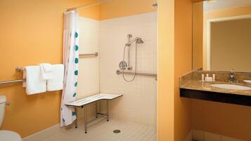 A bathroom with a shower, toilet, and sink.