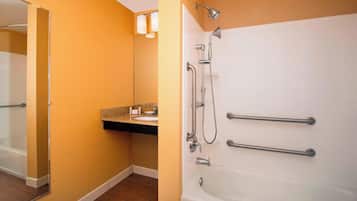 A bathroom with a bathtub, a shower, and a sink.