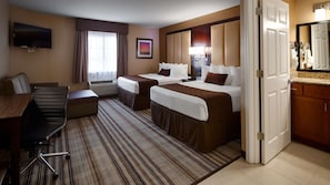 A hotel room with two beds, a desk, a chair, a TV, and a bathroom visible through an open door. - Best Western Plus Crawfordsville Hotel (Crawfordsville)