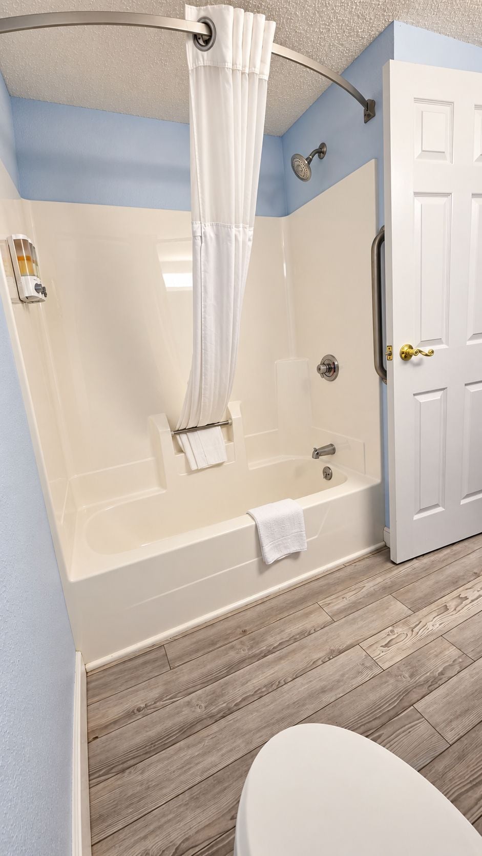 A bathroom with a walk-in shower, a bathtub, and a toilet.