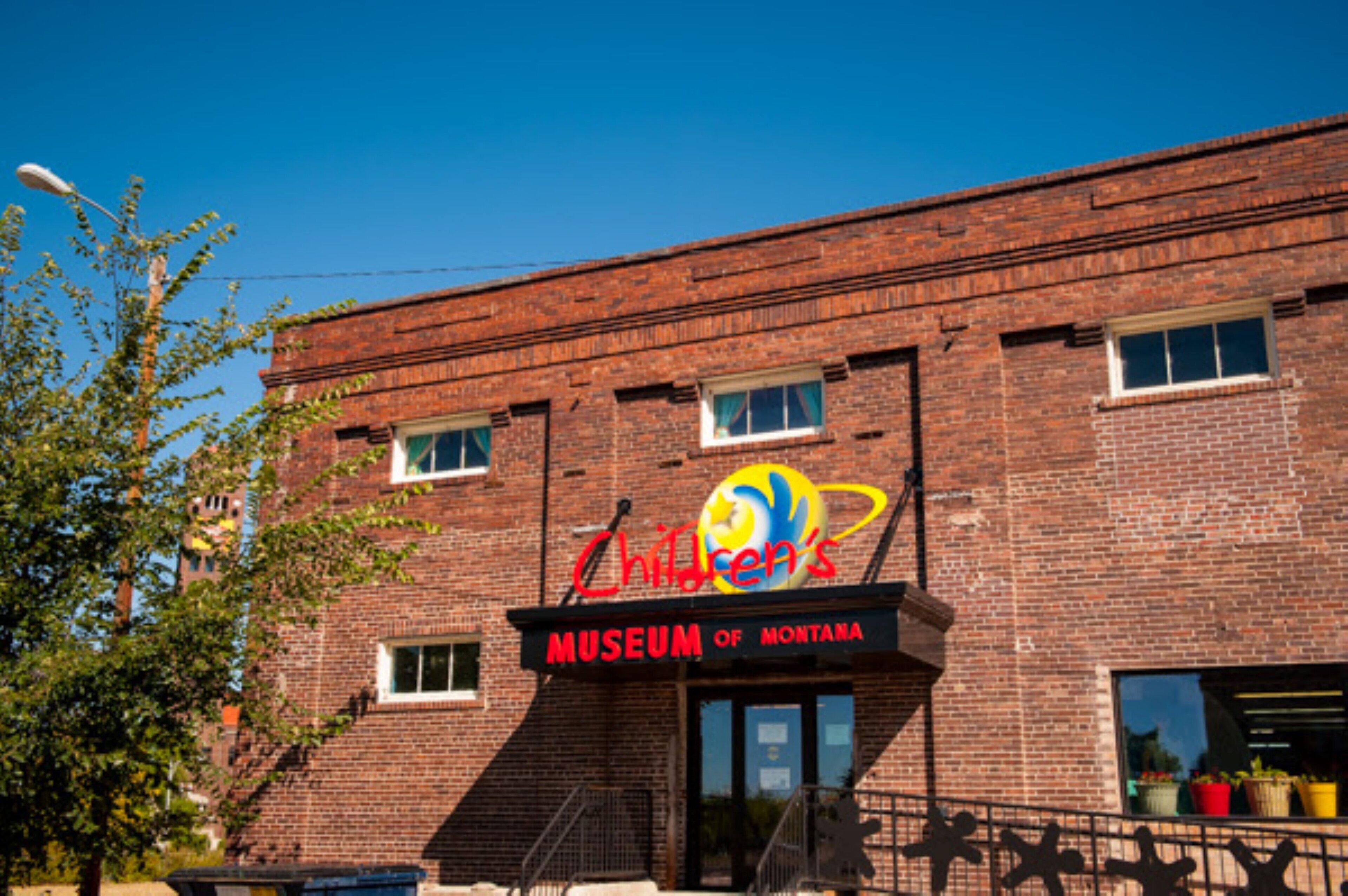 A brick building with a sign reading "Children's Museum of Montana."