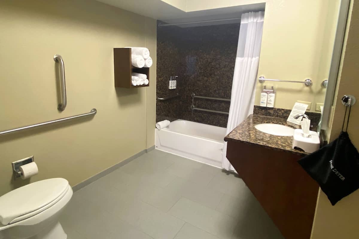 A bathroom with a toilet, a sink, a shower, and a bathtub.