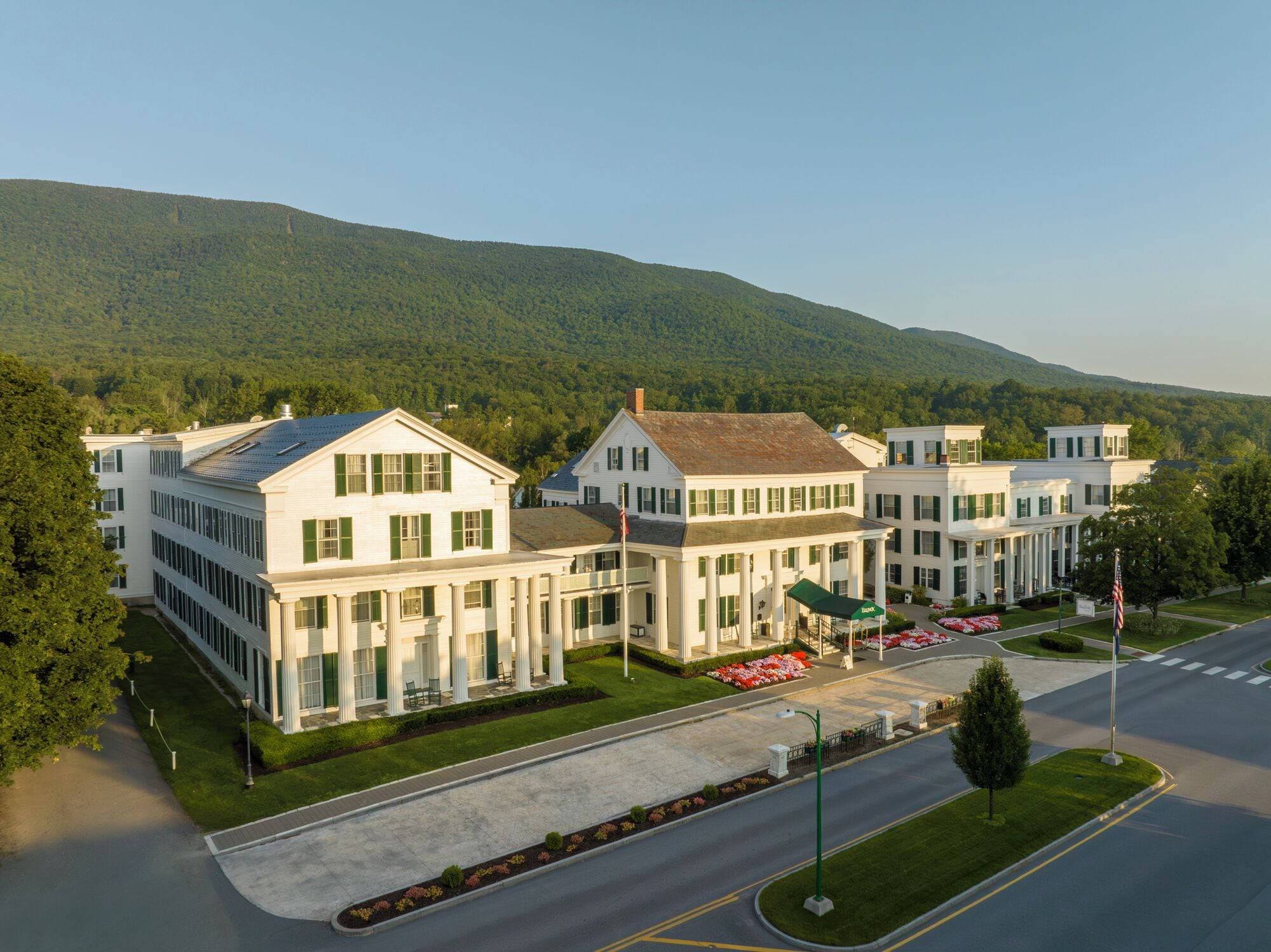 A large, white building with a symmetrical facade, multiple windows, and a central entrance with columns.