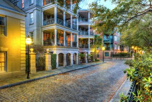 A cobblestone street lined with multi-story buildings featuring balconies and wrought iron gates. - Staybridge Suites North Charleston by IHG (North Charleston)