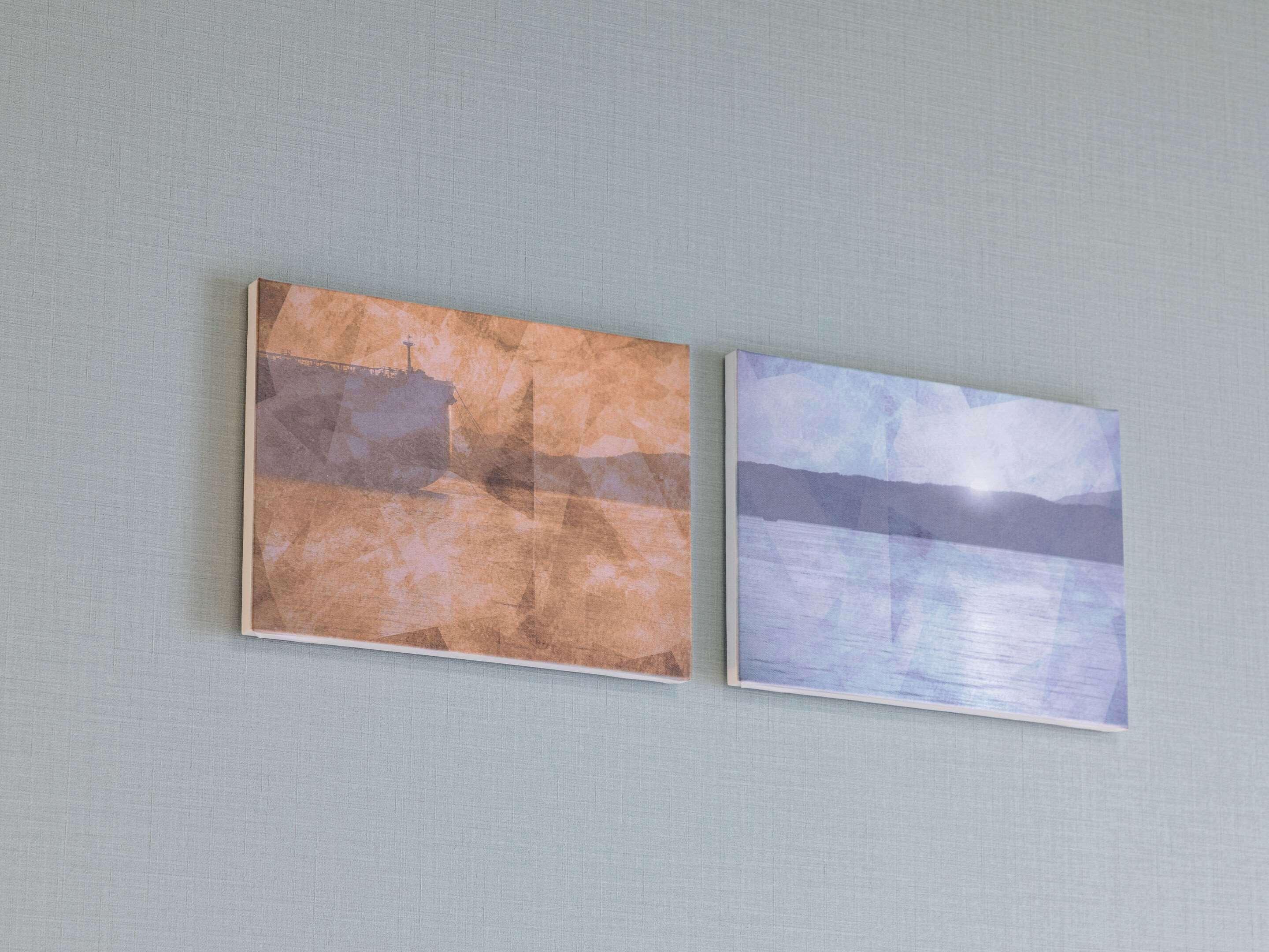 Two framed artworks on a wall.