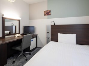 A hotel room with a bed, a desk with a computer, a chair, a telephone, a water dispenser, and a mirror. - Comfort Hotel Kure (Kure)