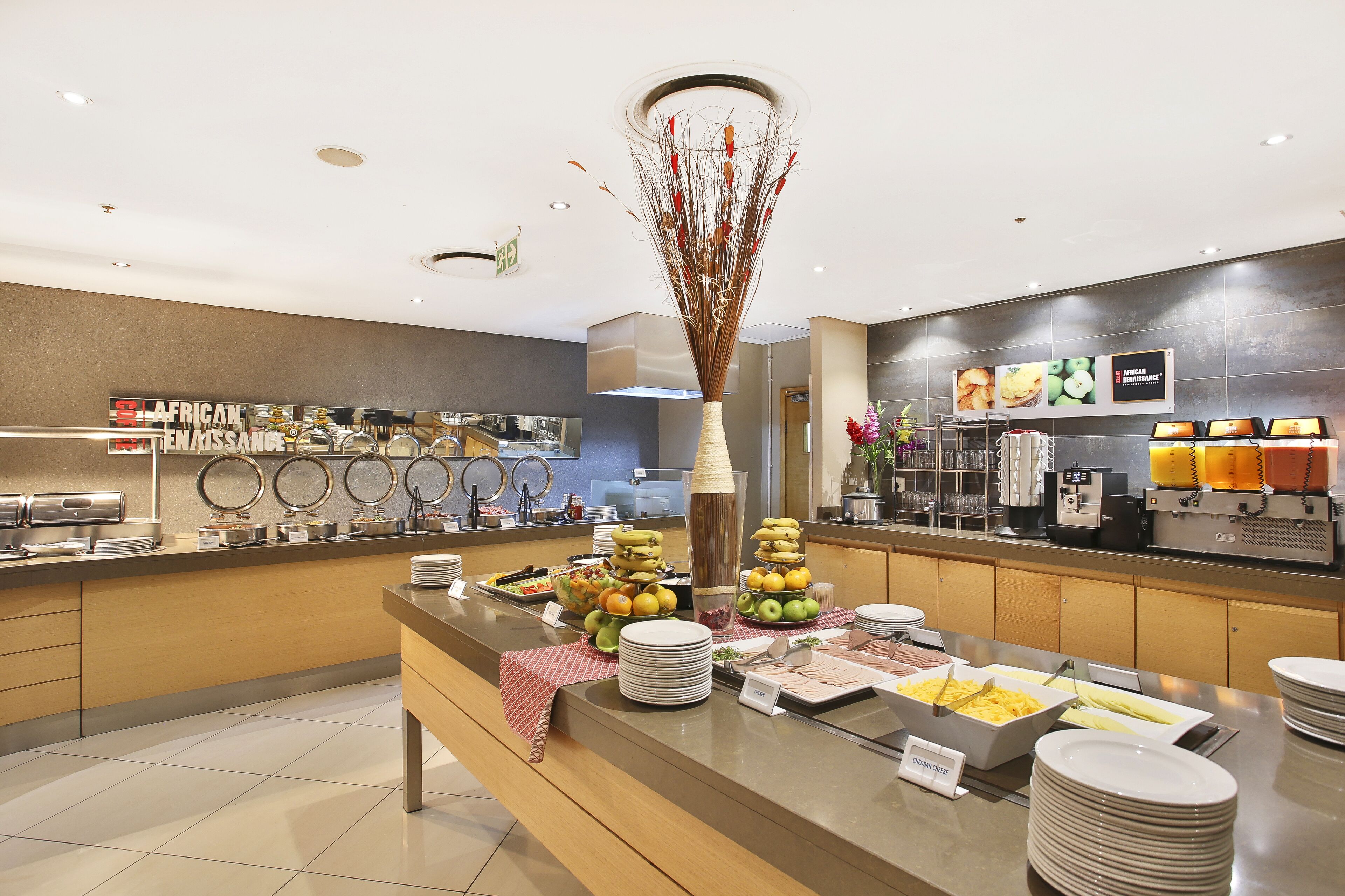A buffet area with various food items and a decorative vase.