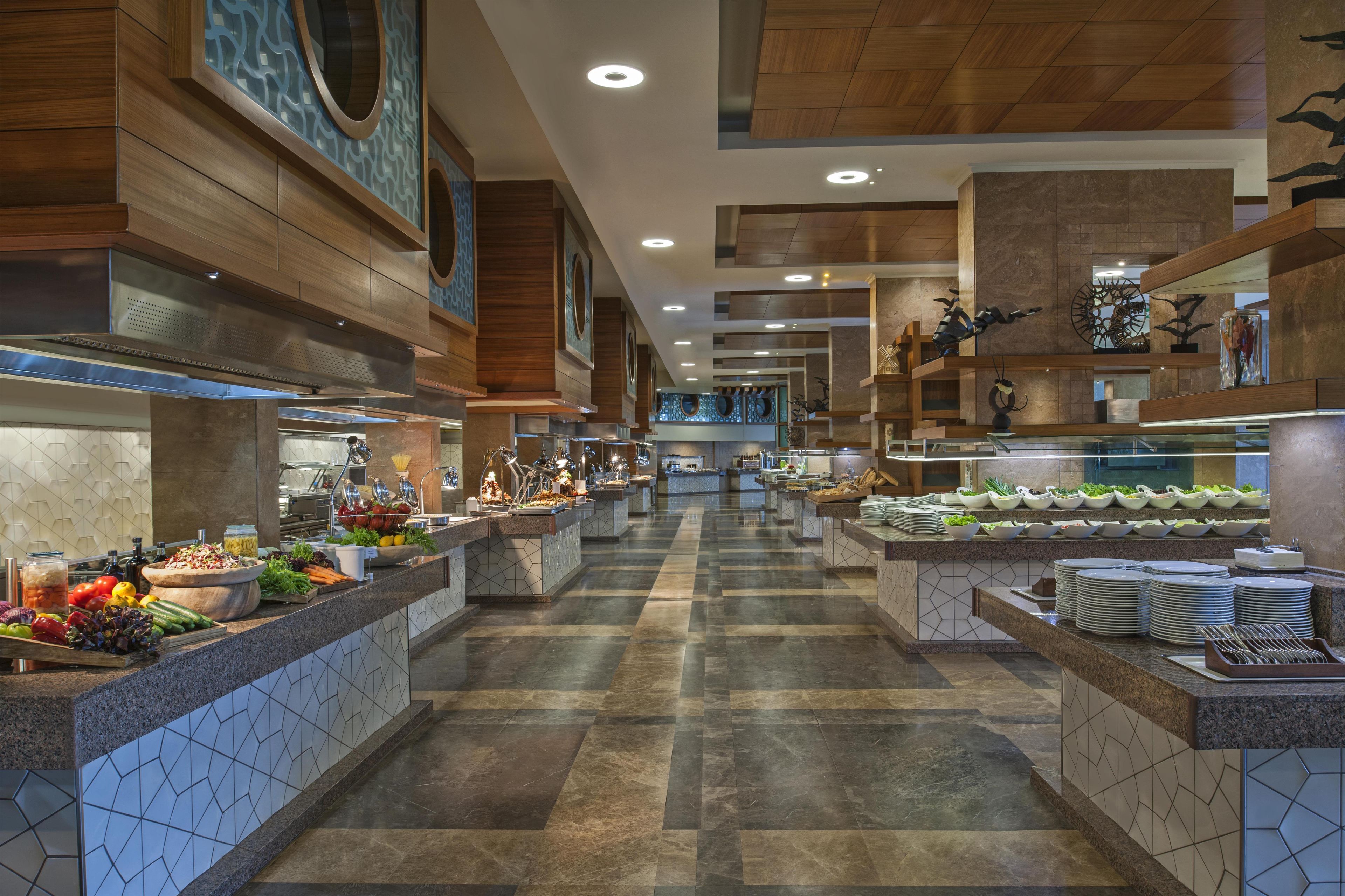 A spacious buffet area with multiple food stations and a central walkway.
