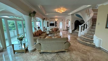 Royal Suite, 3 Bedrooms | Living area | 43-inch TV with cable channels