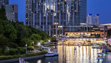 A hotel with a modern glass facade and the name "Sheraton" prominently displayed.
