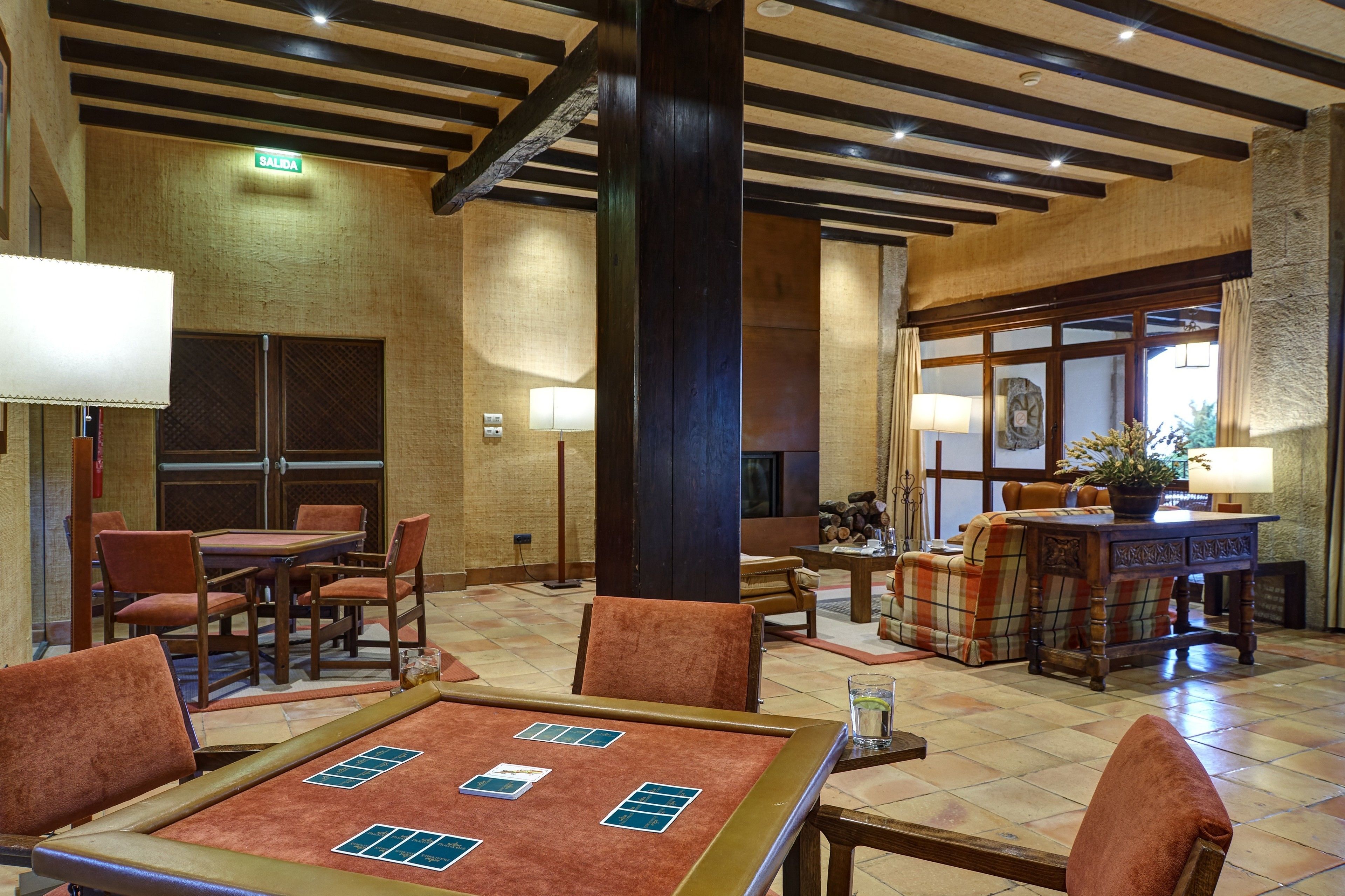 A lobby with a reception desk, seating area, and a fireplace.