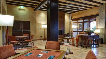 A lobby with a reception desk, seating area, and a fireplace.
