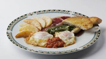 A plate with eggs, bread, and vegetables.