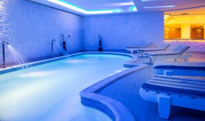 A spa pool with a blue-tiled interior, lounge chairs, and a water feature. - SRNTY Sea Reef - Ex Serenity Alpha Beach (Makadi Bay)