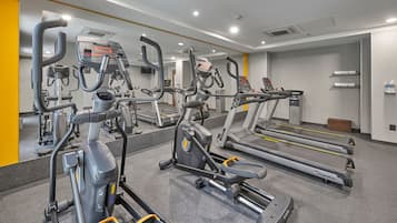 A gym with treadmills, ellipticals, and other cardio equipment.