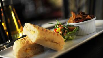 A sandwich and a small salad on a white plate.