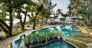 A resort pool with a view of the sea, surrounded by palm trees and lounge areas. - Moracea by Khao Lak Resort (Takua Pa)