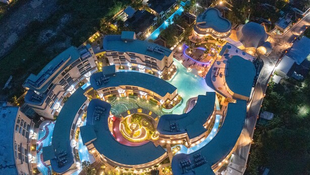 An aerial view of a resort with a central pool, multiple buildings, and well-lit pathways. - Metadee Concept Hotel (Karon)