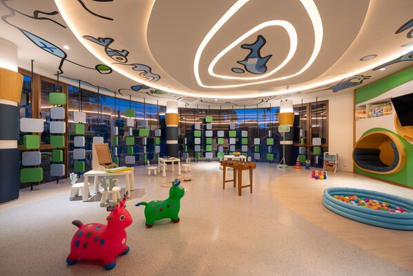 A children's play area with colorful toys, a foosball table, and a ball pit. - Metadee Concept Hotel (Karon)