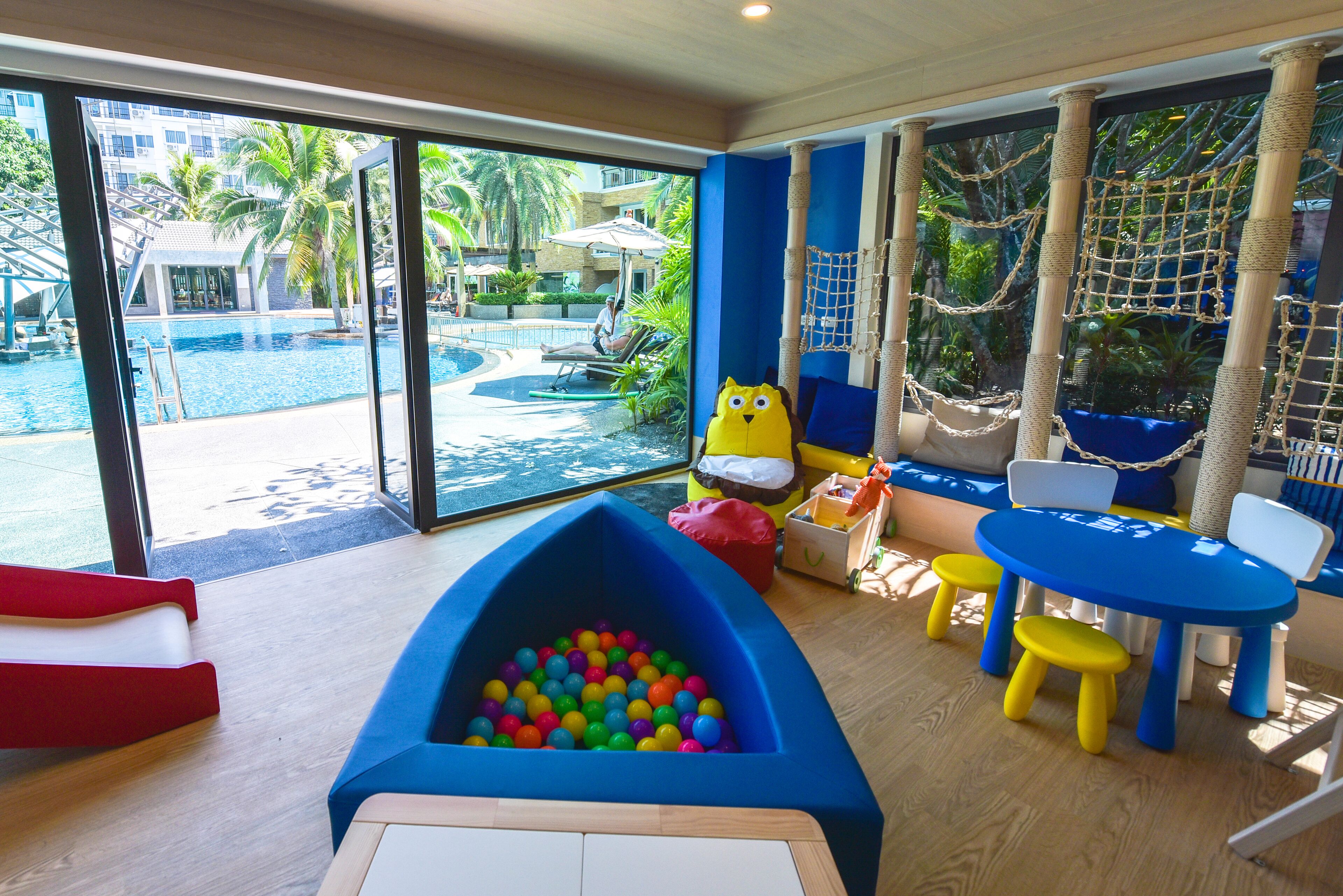 A children's play area with a pool, slides, and a ball pit.
