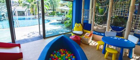 A children's play area with a pool, slides, and a ball pit.