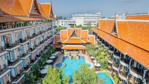 A hotel with multiple balconies, a central swimming pool, and traditional architecture. - Nipa Resort (Patong)