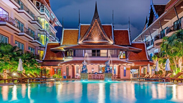 A hotel with a large swimming pool, a traditional Thai architectural style, and multiple balconies. - Nipa Resort (Patong)