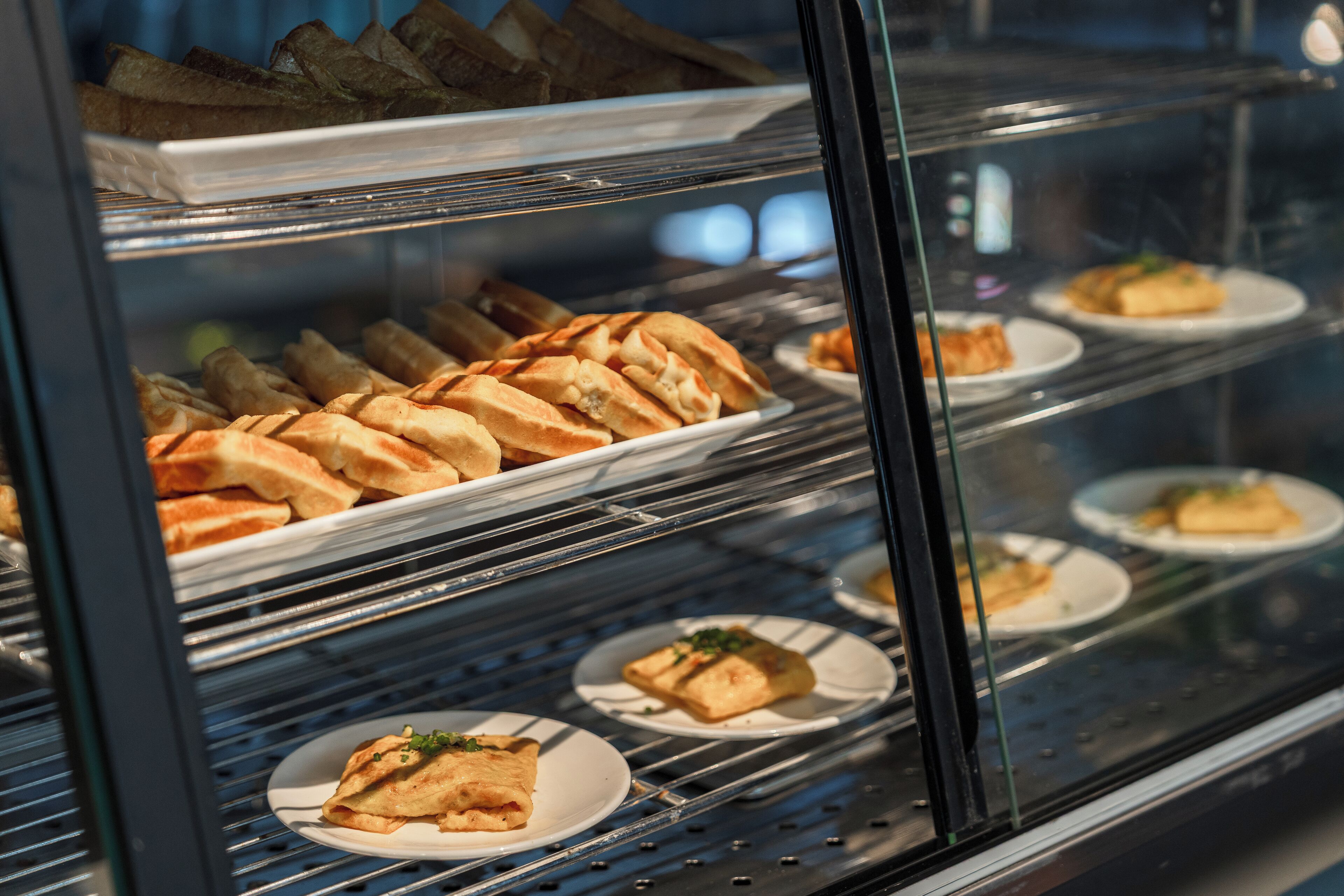 A bakery display case with various baked goods.