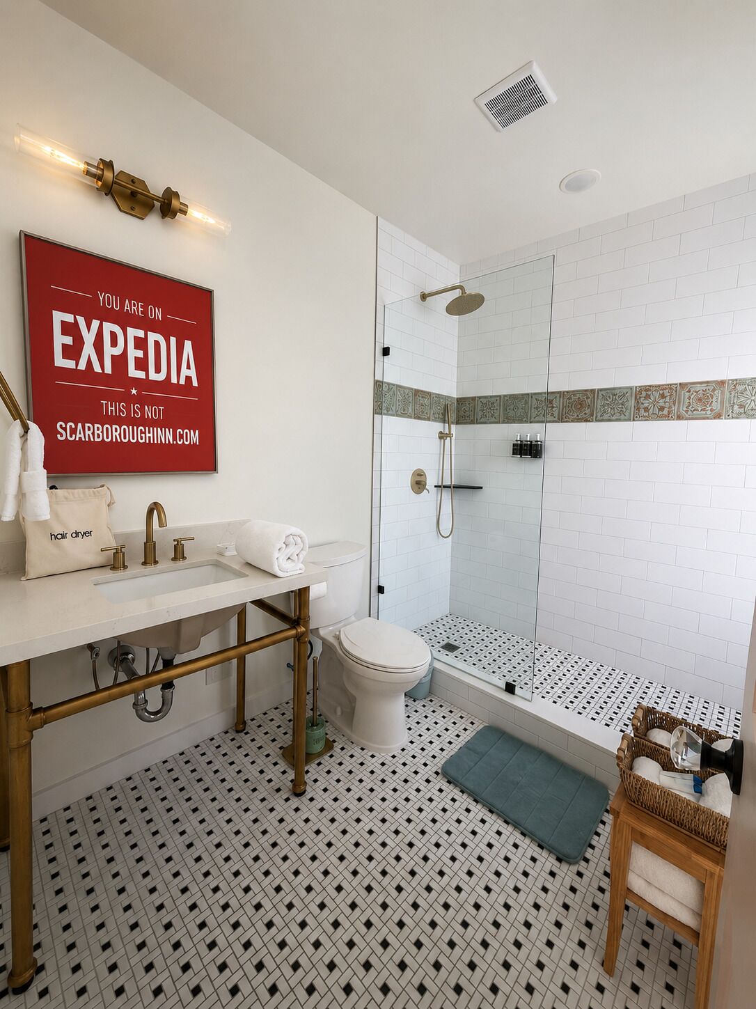 A bathroom with a white sink, toilet, and shower. There is a red sign on the wall and a patterned floor.