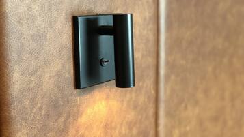 A black door handle on a textured wooden door.