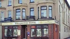 A building with a sign reading "Wellington Hotel". - Wellington Hotel (Blackpool)