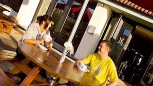 An outdoor seating area with wooden tables and benches.