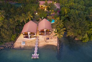 An aerial view of a resort with two large, covered structures, a dock, and a clear view of the surrounding tropical landscape. - Fatumaru Lodge Port Vila (Port Vila)