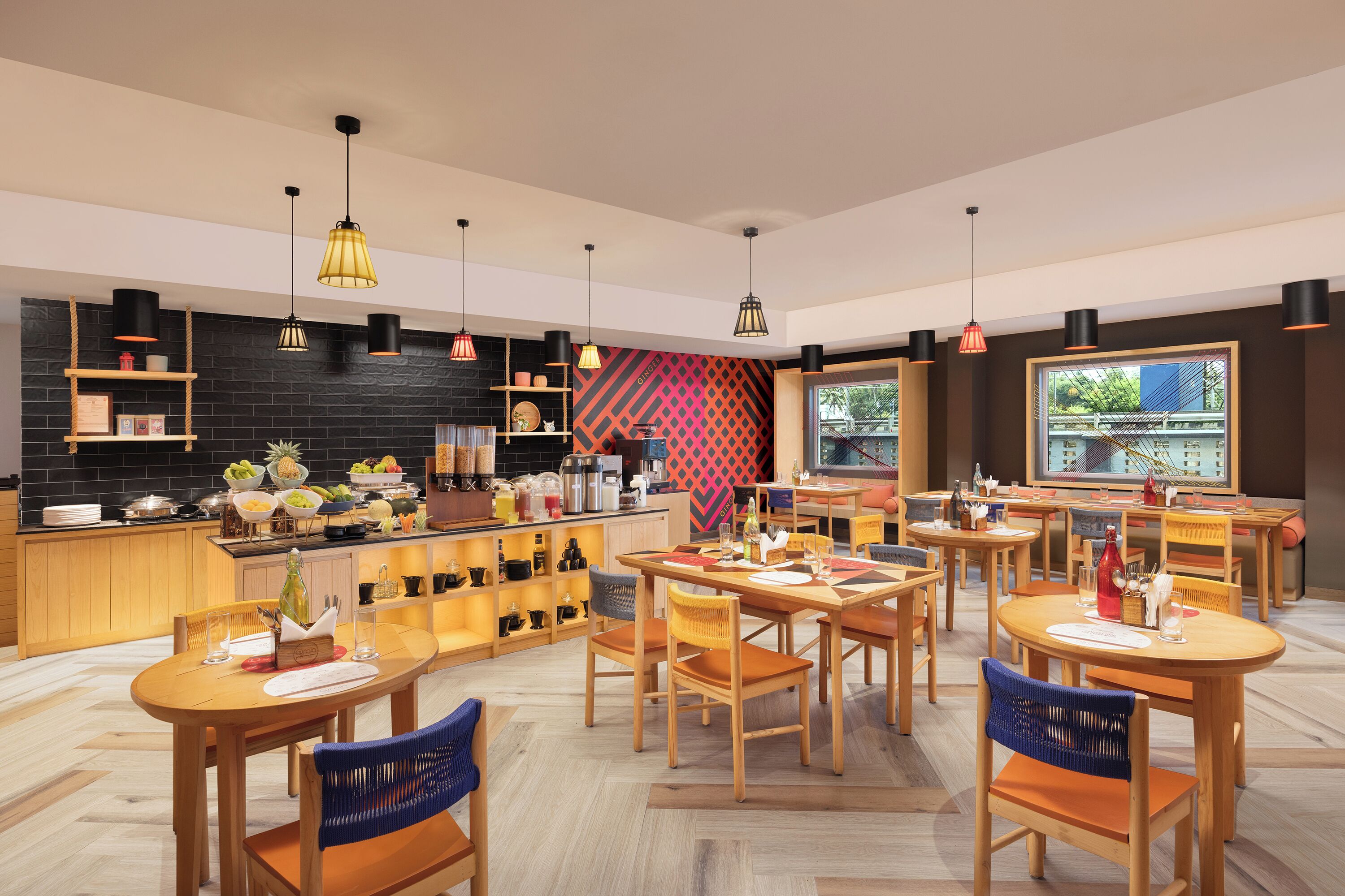 A modern restaurant with wooden furniture, black and red patterned walls, and pendant lighting.