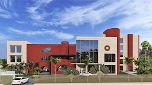 A modern building with a red facade, large windows, and a circular logo. - Ginger Durgapur (Durgapur)