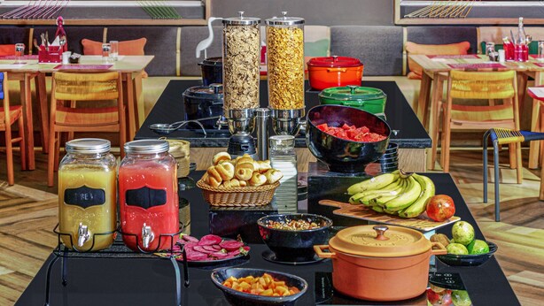 A buffet table with various food items and condiments. - Ginger Mangalore (Mangaluru)