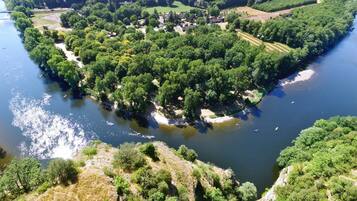 An aerial view of a densely forested island with a river.