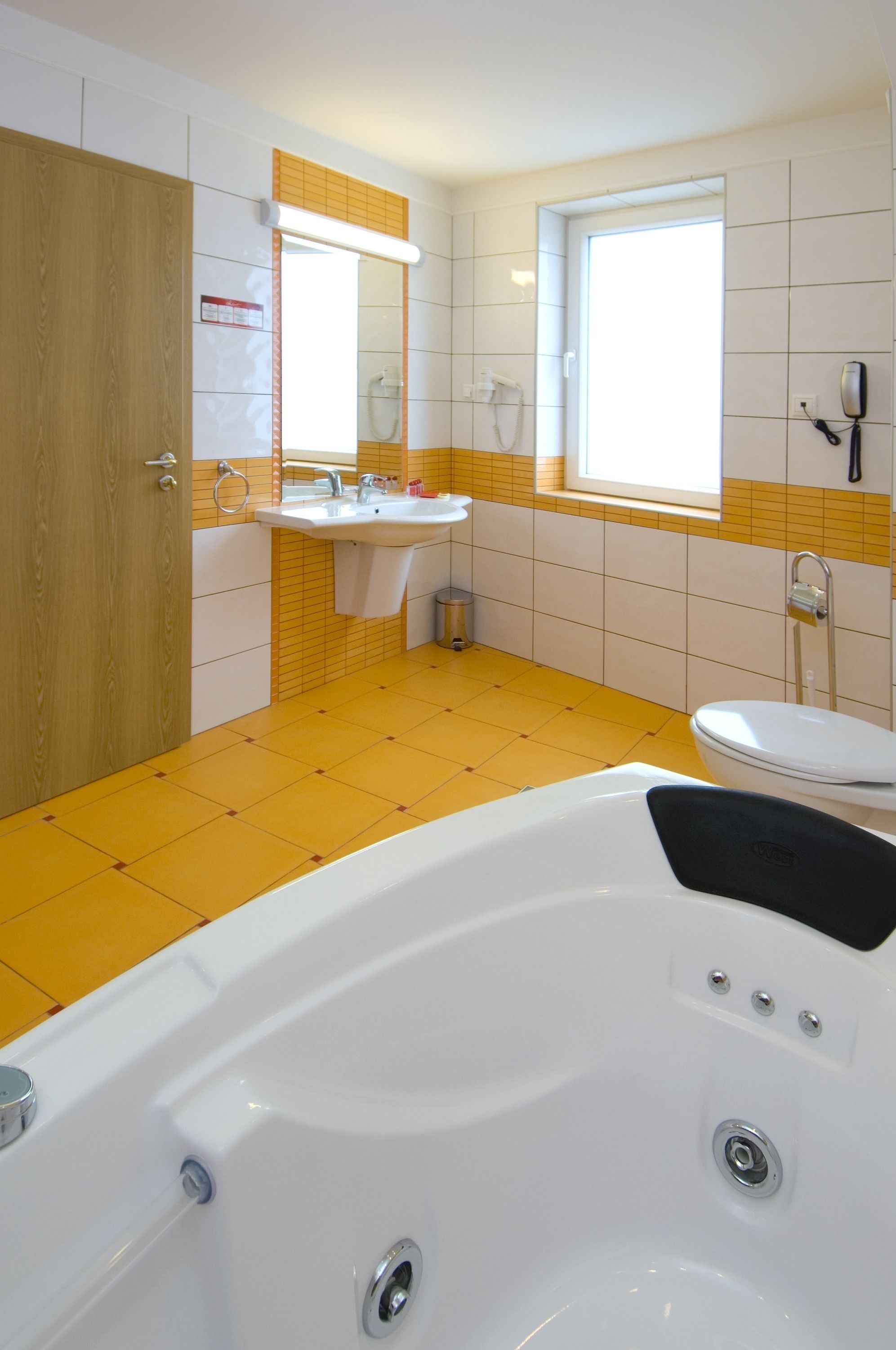 A bathroom with a bathtub, sink, and toilet.