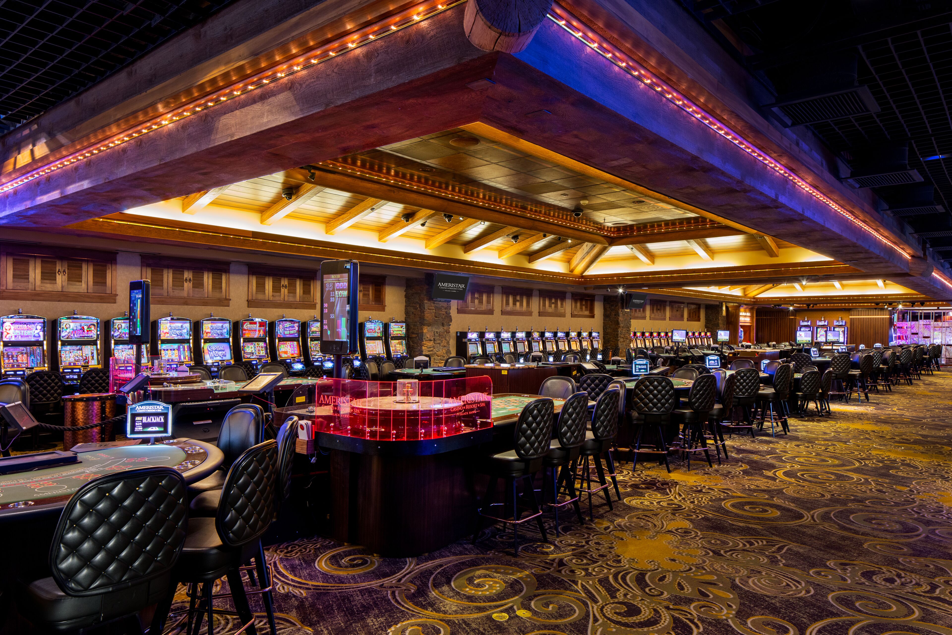 A casino with multiple gaming tables and slot machines.
