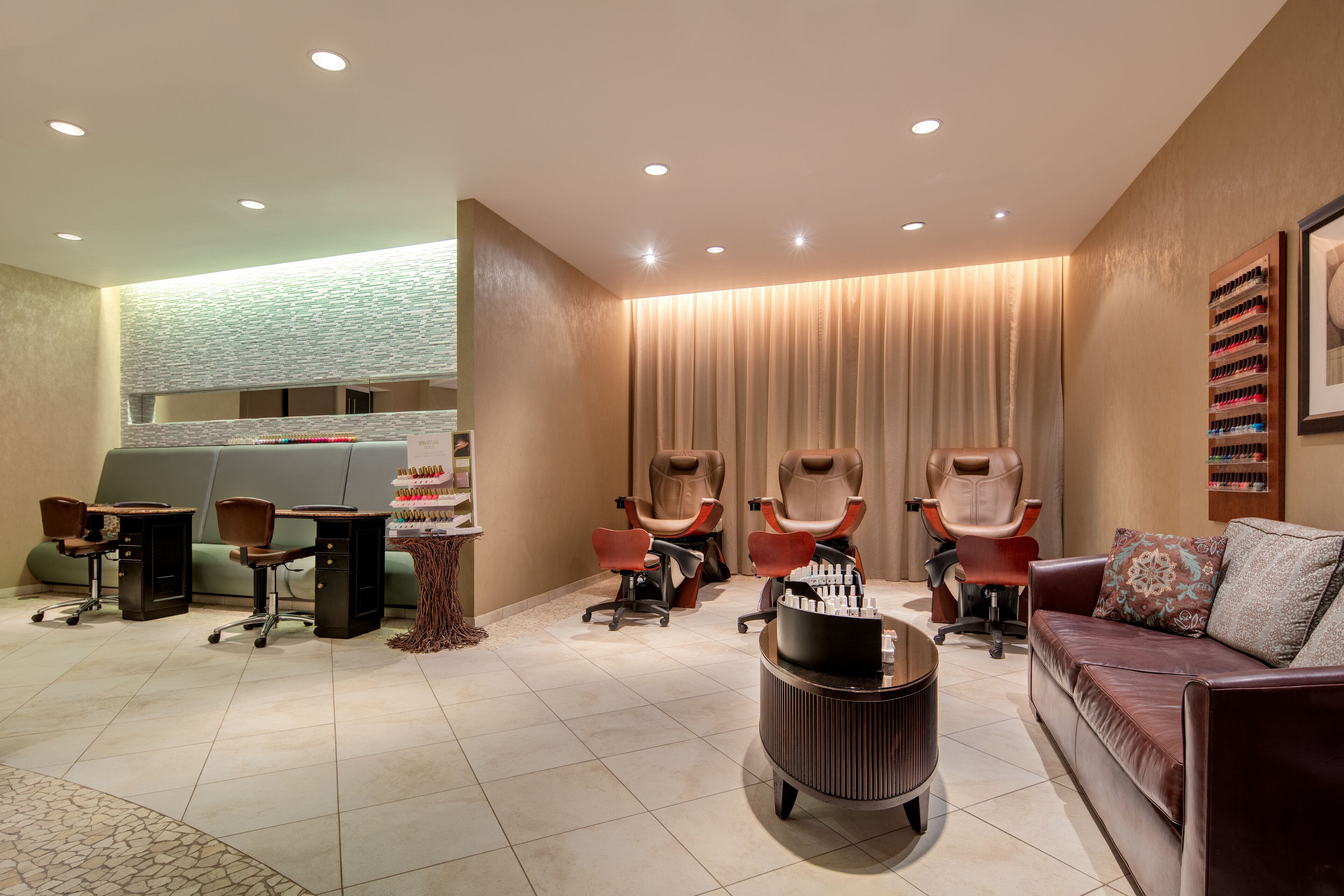 A modern salon with multiple hairdressing stations, a reception area, and a comfortable seating area.